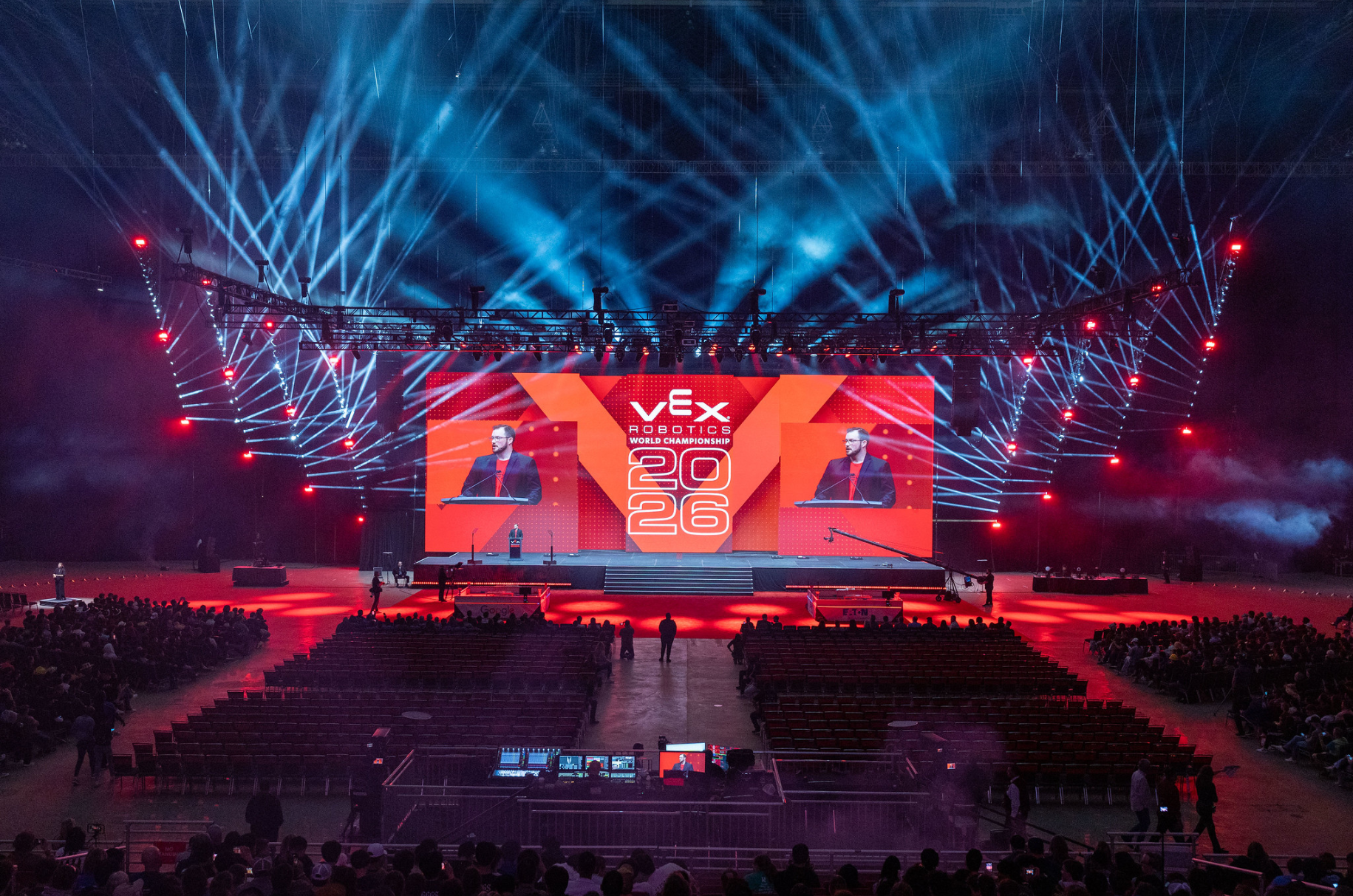 The opening ceremony arena, lit in red and blue, seen from the back of the hall